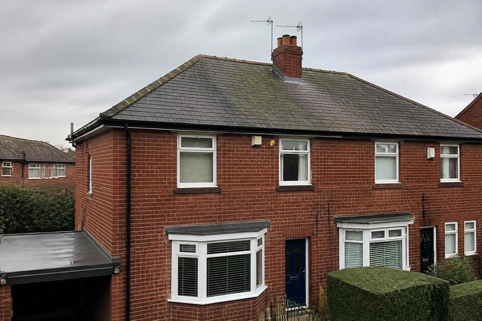 Slate roof replacement on a red brick house in West Yorkshire
